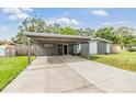 View of the exterior of a single-story home with a covered carport on a sunny day at 2526 W Jean St, Tampa, FL 33614