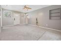 Bright living room with soft carpet and a white door leading to the exterior at 2526 W Jean St, Tampa, FL 33614