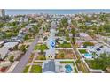 An aerial view shows a yellow home with a white fence in a beautiful neighborhood at 260 42Nd Ave, St Pete Beach, FL 33706