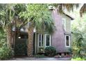 Home with brick chimney and tropical landscaping, enhancing its curb appeal at 272 Orange St, Palm Harbor, FL 34683