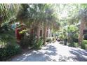 Home with brick accents and lush landscaping, creating a private oasis at 272 Orange St, Palm Harbor, FL 34683