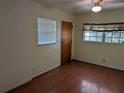 Cozy bedroom featuring hardwood floors, a ceiling fan, and a bright window at 503 Sunset Rd, Plant City, FL 33563