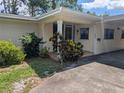 Welcoming front entrance with a covered porch and well-maintained landscaping at 503 Sunset Rd, Plant City, FL 33563