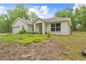 Inviting single-story home with attached garage, manicured lawn, and charming entrance porch perfect for relaxing at 5422 Wilkins Trl, Brooksville, FL 34602