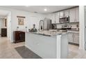 Open kitchen featuring granite countertops, stainless steel appliances, and tile flooring at 5687 Barakat Rd, Zephyrhills, FL 33541