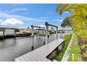 Dock and boat lift in backyard canal with water access; several docks are lined up along the canal at 6528 Simone Shores Cir, Apollo Beach, FL 33572