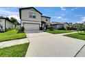 Wide driveway and manicured lawn of a two-story home in a well-kept neighborhood at 6658 Devlin Ln, Wesley Chapel, FL 33545