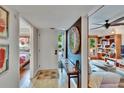 Inviting foyer features a decorative mirror, stylish bench, and opens to the living room and bedroom at 675 64Th S Ave, St Petersburg, FL 33705