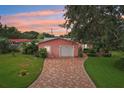 A well-maintained single-Gathering home with a brick driveway and a two-car garage at 6897 18Th N St, St Petersburg, FL 33702