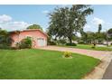 A well-maintained single-Gathering home with a spacious front yard and brick driveway at 6897 18Th N St, St Petersburg, FL 33702