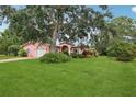 A single-Gathering house with a large front lawn and mature trees at 6897 18Th N St, St Petersburg, FL 33702