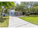 Inviting one-story home with well-maintained lawn, mature trees, and accessible ramp leading to the entrance at 715 W 109Th Ave, Tampa, FL 33612