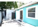 Backyard view of the home shows door to bonus space and fenced exterior at 7510 N Tampania Ave, Tampa, FL 33614