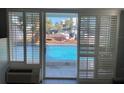 Patio doors open to views of a sparkling swimming pool in an inviting outdoor space at 800 Bayway Blvd # 14, Clearwater Beach, FL 33767