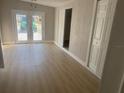 Spacious living room with light-colored floors and sliding glass doors to the backyard at 8502 Grapefruit Ave, Tampa, FL 33619