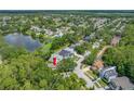An aerial view showcases this home's location within a serene neighborhood, near a pond and surrounded by trees at 8514 Manassas Rd, Tampa, FL 33635