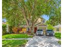 Inviting two-story home with mature trees, well-maintained lawn, and a convenient two-car driveway at 8514 Manassas Rd, Tampa, FL 33635