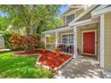 Close-up view of home's inviting front porch, complete with decorative planters and comfortable seating area at 8514 Manassas Rd, Tampa, FL 33635