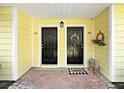 Charming dual entrances with decorative wreaths and lanterns create a welcoming and stylish entryway at 9731 Meadow Field Cir, Tampa, FL 33626