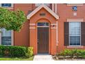 Inviting home entrance with a decorative door and neatly trimmed bushes at 9842 Lake Chase Island Way, Tampa, FL 33626