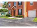 Beautiful townhome with a private garage and a lush green lawn at 9842 Lake Chase Island Way, Tampa, FL 33626