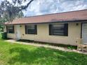 A cozy single-story home featuring a well-kept lawn and traditional window shutters at 9902 N Myrtle St, Tampa, FL 33617