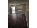 Bright living room featuring sleek floors, a large window, and an open entryway at 9902 N Myrtle St, Tampa, FL 33617