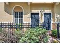Exterior view of townhomes featuring private entrances and manicured landscaping at 113 S Sherrill St # 113, Tampa, FL 33609