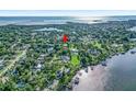 Aerial view of home amid a lush, green neighborhood close to the water at 1217 N Florida Ave, Tarpon Springs, FL 34689