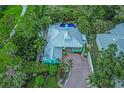 Aerial view of vibrant home and manicured yard. Features a rooftop pool at 1217 N Florida Ave, Tarpon Springs, FL 34689