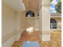 Inviting home entrance with double doors, neutral stucco, and low maintenance landscaping at 13094 Huntington Woods Ave, Spring Hill, FL 34609