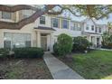 Charming townhouse with a well-maintained lawn and mature shade trees framing the exterior at 13521 Forest Lake Dr, Largo, FL 33771