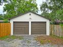 Two-car detached garage with traditional carriage doors and exterior architectural details at 1620 15Th N St, St Petersburg, FL 33704