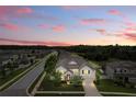 Beautiful home with manicured lawn in quiet neighborhood under a vibrant sunset sky at 18696 Malinche Loop, Spring Hill, FL 34610
