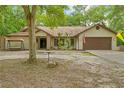A charming single-Gathering home boasts a well-manicured lawn and attached two car garage at 19555 Phillips Rd, Brooksville, FL 34604