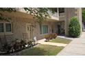 A bright condo unit featuring brick facade, complemented by manicured plants, and a welcoming doorway at 2192 Swedish Dr # 10, Clearwater, FL 33763
