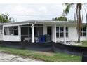 Quaint single-story home features a screened in porch and bright natural light at 2470 Del Rio Way, Dunedin, FL 34698