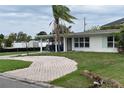 Charming single-story home with a cozy carport and beautiful mature palm tree at 2470 Del Rio Way, Dunedin, FL 34698