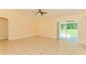 Bright living room with tile flooring, ceiling fan, and sliding door access to the outside at 2718 Chipley Ave, North Port, FL 34286