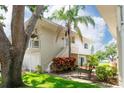 Two-story home with white exterior and a small balcony above garage, set amongst a green lawn at 2943 Bough Ave # C, Clearwater, FL 33760