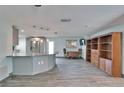Open living space with kitchen, wood-look flooring, and modern lighting at 3619 15Th Se Ave, Largo, FL 33771