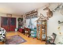 Comfortable room with wood-look floors, space for office area, with door leading outside at 36725 Arcadia Ave, Myakka City, FL 34251