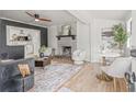 Open-concept living room with brick fireplace, wood floors, and stylish furnishings, creating an inviting atmosphere at 5622 Tangerine S Ave, Gulfport, FL 33707