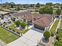 Aerial view of the home with a long driveway, fenced yard, and mature landscaping at 5812 Blossom Ave, Tampa, FL 33614