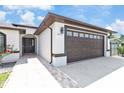 Close up of the home's exterior showing the front door, walkway and two car garage at 5812 Blossom Ave, Tampa, FL 33614