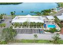 Aerial view of condos with pool, parking, mature palms, and professionally maintained landscaping at 611 Destiny Dr, Ruskin, FL 33570