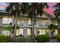 Condo building exterior with balconies, mature palms, and freshly painted exterior at 611 Destiny Dr, Ruskin, FL 33570