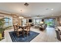 Open floor plan features living room, dining area and access to the outdoors at 6127 Colmar Pl, Apollo Beach, FL 33572