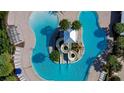 Aerial view of a uniquely shaped pool featuring water slides and ample lounge seating at 6127 Colmar Pl, Apollo Beach, FL 33572