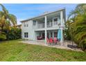 Expansive backyard featuring a patio, lush lawn, and tropical landscaping, ideal for outdoor living at 6416 Grenada Island Ave, Apollo Beach, FL 33572